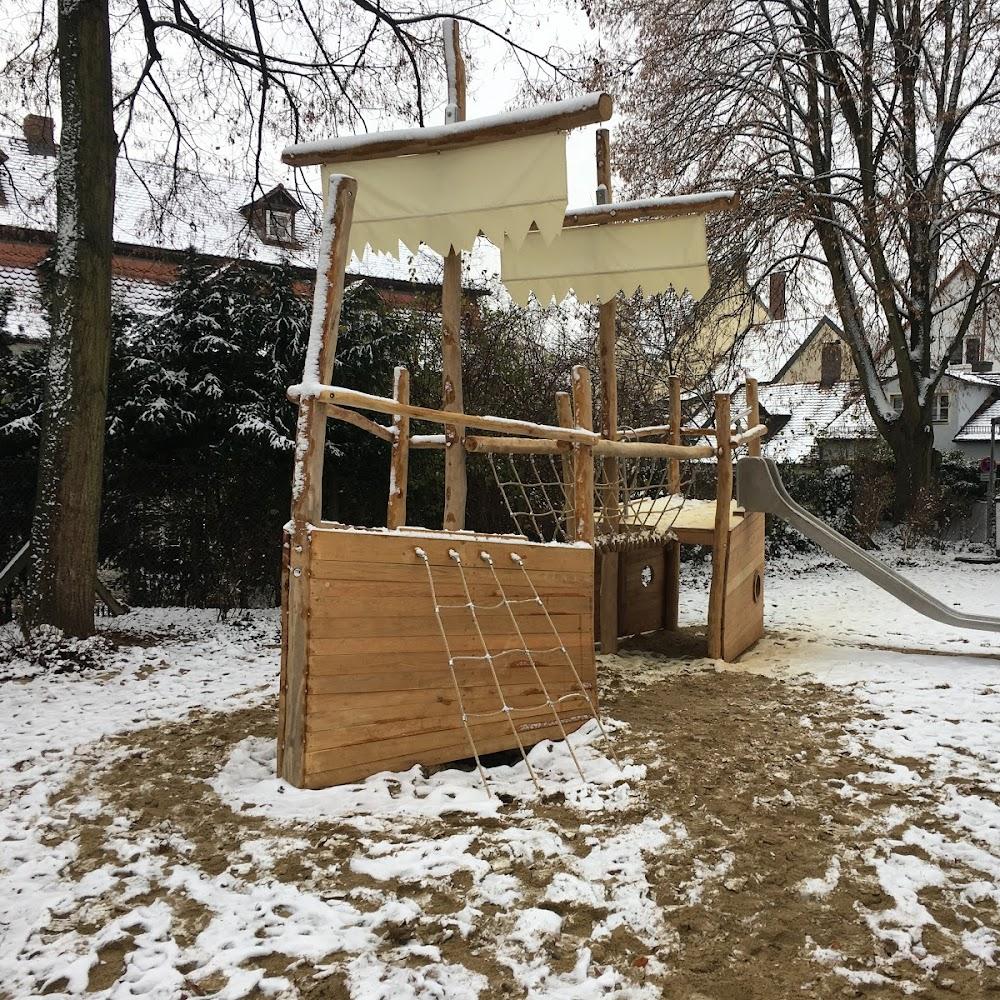 Wooden playground structure shaped like a ship in the snow.